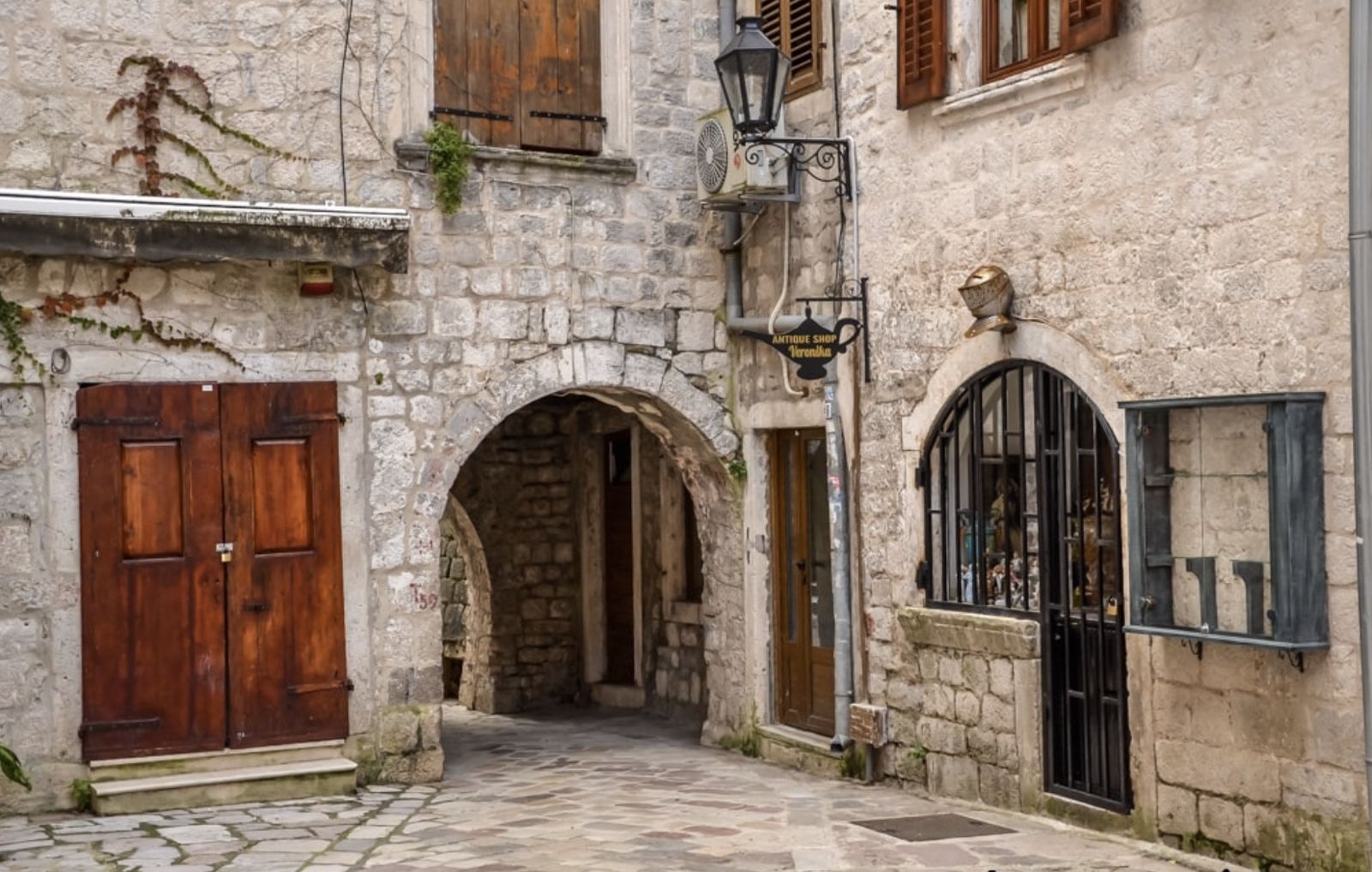A stone arch and wooden doors in Kotor old town