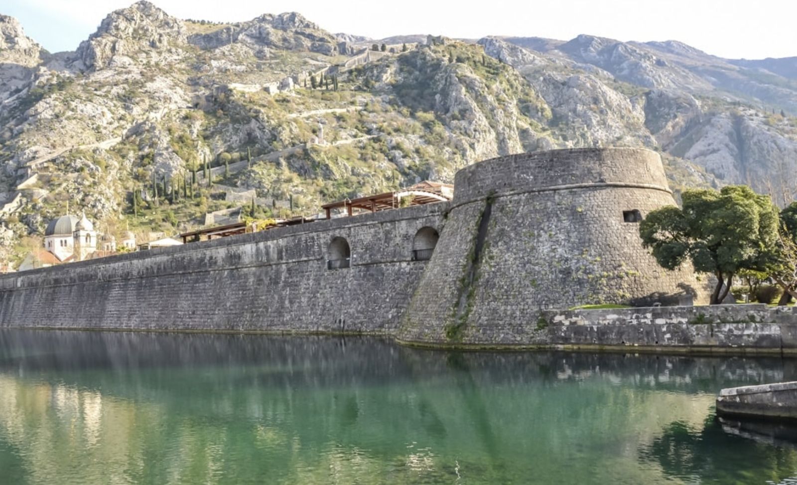 Kotor's old town walls reflected in the water